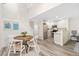 Dining room with light-toned hardwood floors near the kitchen and a staircase to the second floor at 2017 N Fork Dr, Lafayette, CO 80026