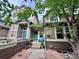 Charming townhome with covered entry, stylish door, and landscaping, set against a backdrop of mature trees at 2017 N Fork Dr, Lafayette, CO 80026