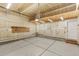 View of a large two car garage with a work bench, storage, and freshly painted walls at 2017 N Fork Dr, Lafayette, CO 80026