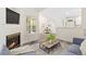 Inviting living room with fireplace, wood flooring, and a seamless view to the dining area at 2017 N Fork Dr, Lafayette, CO 80026