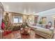 Living room showcasing a sectional sofa, Christmas tree, and hardwood floors at 1916 S Logan St, Denver, CO 80210