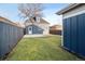 Quaint backyard with green lawn, privacy fence, detached garage and alley access at 2515 Zenobia St, Denver, CO 80212