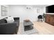 Basement with hardwood floors, gray sofa, and decorative rug at 2515 Zenobia St, Denver, CO 80212