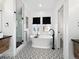 Elegant bathroom with a soaking tub, tiled shower, and geometric patterned floor at 2515 Zenobia St, Denver, CO 80212