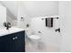 Charming bathroom with blue vanity and modern black hardware at 2515 Zenobia St, Denver, CO 80212