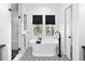 Stylish bathroom features a soaking tub, tiled shower, and black and white accents at 2515 Zenobia St, Denver, CO 80212