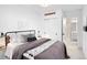 Bedroom with neutral decor, slider closet, and attached bathroom at 2515 Zenobia St, Denver, CO 80212