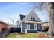 Charming blue two-story home with a well-maintained lawn and inviting front porch at 2515 Zenobia St, Denver, CO 80212