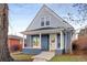 Inviting two-story home featuring a covered front porch with classic white columns at 2515 Zenobia St, Denver, CO 80212