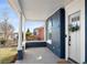 Covered front porch with classic columns and inviting entrance with views of the neighborhood at 2515 Zenobia St, Denver, CO 80212