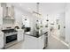 Modern kitchen with stainless steel appliances and a large island with a black countertop at 2515 Zenobia St, Denver, CO 80212