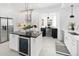 Modern kitchen with stainless steel appliances, white cabinets, and sleek black countertops at 2515 Zenobia St, Denver, CO 80212