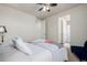 Bedroom with ceiling fan, neutral walls, and connecting door to the bathroom at 27029 E Irish Pl, Aurora, CO 80016