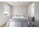 Bright bedroom featuring a chandelier, built-in storage, and a workspace in the adjoining room at 27029 E Irish Pl, Aurora, CO 80016
