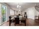 Open concept dining room with stairs leading upstairs, as well as a fireplace and lounge area at 27029 E Irish Pl, Aurora, CO 80016