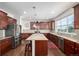 Kitchen with marble counter tops, wooden cupboards and drawers, and stainless steel appliances at 27029 E Irish Pl, Aurora, CO 80016