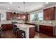 Open kitchen with stainless steel appliances, granite countertops, and center island with bar stool seating at 27029 E Irish Pl, Aurora, CO 80016