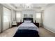This main bedroom has a chandelier, tray ceiling, bedside lamps, and neutral colored walls at 27029 E Irish Pl, Aurora, CO 80016