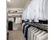 This walk-in closet has plenty of built-in shelving, hanging storage, and a dark colored cabinet at 27029 E Irish Pl, Aurora, CO 80016