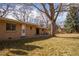 Large yard with mature trees and a brick house at 430 Long View Ct, Longmont, CO 80501