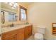 Bathroom featuring a vanity with granite countertops and a window with sheer curtains at 430 Long View Ct, Longmont, CO 80501