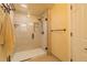 Bathroom featuring an all-glass shower with light neutral tile and a matching towel at 430 Long View Ct, Longmont, CO 80501