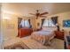 Bedroom with neutral carpet, ceiling fan, decorative window treatments, and dresser with speakers at 430 Long View Ct, Longmont, CO 80501