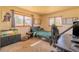 Bright bedroom featuring two windows, neutral carpet, desk, and bed with decorative green comforter at 430 Long View Ct, Longmont, CO 80501
