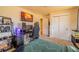 Bedroom featuring a mounted TV, carpet, closet, and desk in a neutral color palette at 430 Long View Ct, Longmont, CO 80501