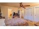 Bedroom with ceiling fan, neutral carpet, walk-in closet, and ensuite bathroom at 430 Long View Ct, Longmont, CO 80501