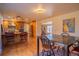Open-concept dining room adjoining kitchen, featuring bar stool seating and natural lighting at 430 Long View Ct, Longmont, CO 80501