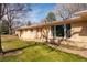 Ranch home featuring a brick exterior, manicured lawn, and mature trees, creating a picturesque setting at 430 Long View Ct, Longmont, CO 80501