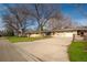 Single-story home with a well-maintained lawn, attached garage, and plenty of parking space at 430 Long View Ct, Longmont, CO 80501
