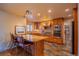 Updated kitchen featuring a breakfast bar, stainless appliances, and hardwood cabinets at 430 Long View Ct, Longmont, CO 80501