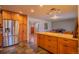 Modern kitchen with stainless steel refrigerator, hardwood cabinets and floors at 430 Long View Ct, Longmont, CO 80501