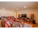 Spacious living room featuring a large sofa, entertainment center, and hardwood floors at 430 Long View Ct, Longmont, CO 80501