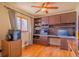 Functional office space with built-in desk, cabinets, and hardwood floors at 430 Long View Ct, Longmont, CO 80501