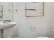 Bathroom featuring pedestal sink, modern fixtures, and a clean, minimalist design at 17962 E 103Rd Ave, Commerce City, CO 80022