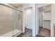 Bathroom shower with a glass door and tiled walls at 17962 E 103Rd Ave, Commerce City, CO 80022