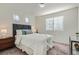 Serene bedroom with natural light, neutral tones, and plush bedding, offering a relaxing retreat at 17962 E 103Rd Ave, Commerce City, CO 80022