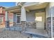 Inviting front porch featuring stone pillars and a cozy entrance to welcome you home at 17962 E 103Rd Ave, Commerce City, CO 80022