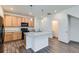 Stylish kitchen with wood cabinets, black appliances, and a granite-topped island, designed for modern cooking at 17962 E 103Rd Ave, Commerce City, CO 80022
