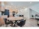 Modern open-concept kitchen with wood flooring, granite island, and updated appliances, perfect for gatherings at 17962 E 103Rd Ave, Commerce City, CO 80022