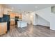 Open kitchen with wood cabinets, black appliances, a granite island, and gray floors, blending style and function at 17962 E 103Rd Ave, Commerce City, CO 80022