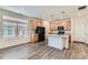Modern kitchen featuring wood cabinets, black appliances, granite countertops, and an island, perfect for cooking at 17962 E 103Rd Ave, Commerce City, CO 80022