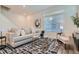 Comfortable living room with a plush sofa, modern decor, and lots of natural light, great for relaxation at 17962 E 103Rd Ave, Commerce City, CO 80022