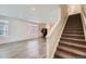 Sunlit living room with wood floors and staircase at 17962 E 103Rd Ave, Commerce City, CO 80022
