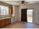 The kitchen features tile flooring, a window, and a door to the outside fenced-in space at 10469 E Abilene St, Commerce City, CO 80022