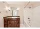 Bathroom features a dark wood vanity, white subway tile, and a shower-tub combination at 9481 E Mansfield Ave # 305, Aurora, CO 80014