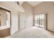 Spacious bedroom with a sliding glass door to a balcony, and neutral carpeting at 9481 E Mansfield Ave # 305, Aurora, CO 80014